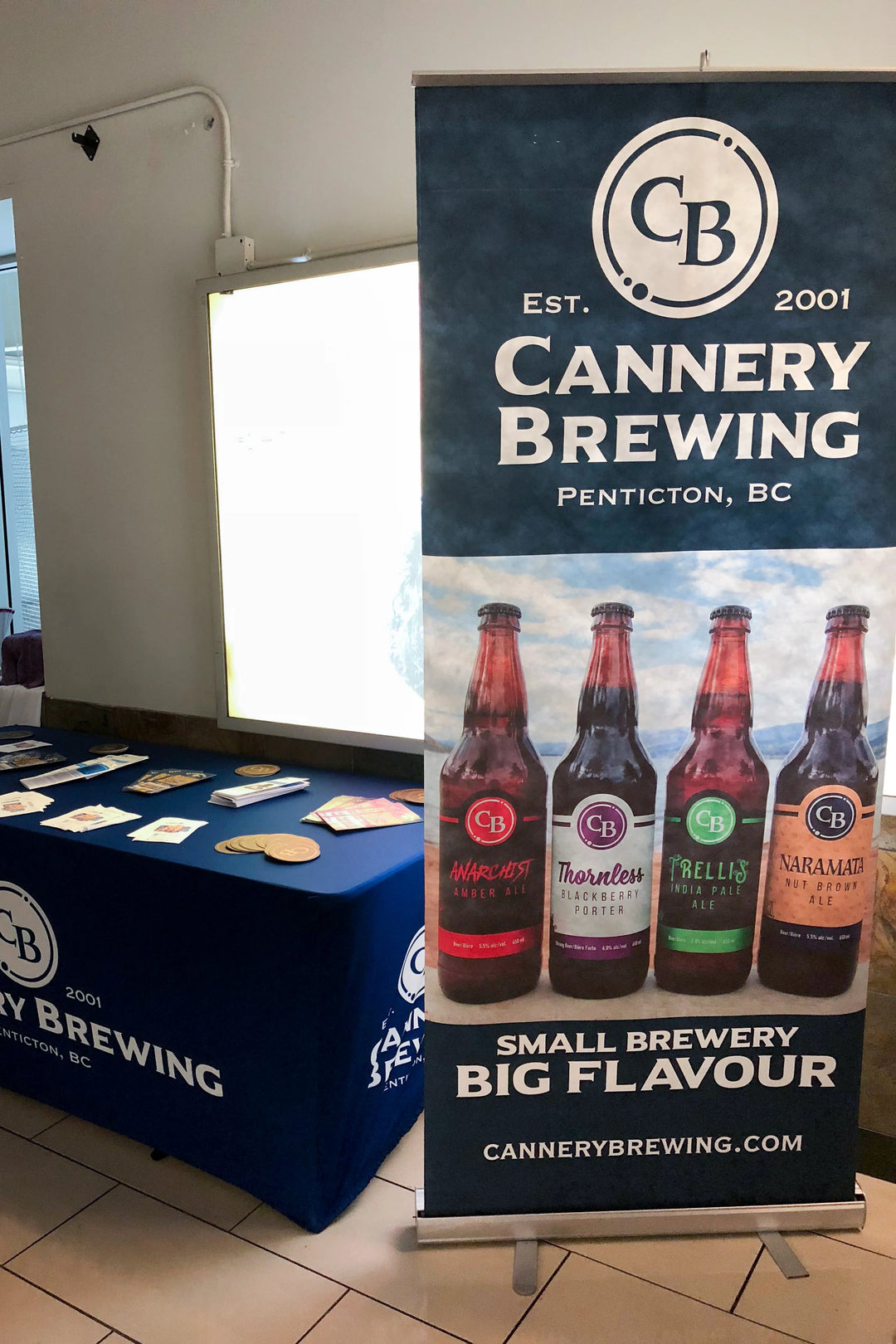 Retractable display banner featuring Cannery Brewing beer lineup with the slogan 'Small Brewery Big Flavour' at a promotional event