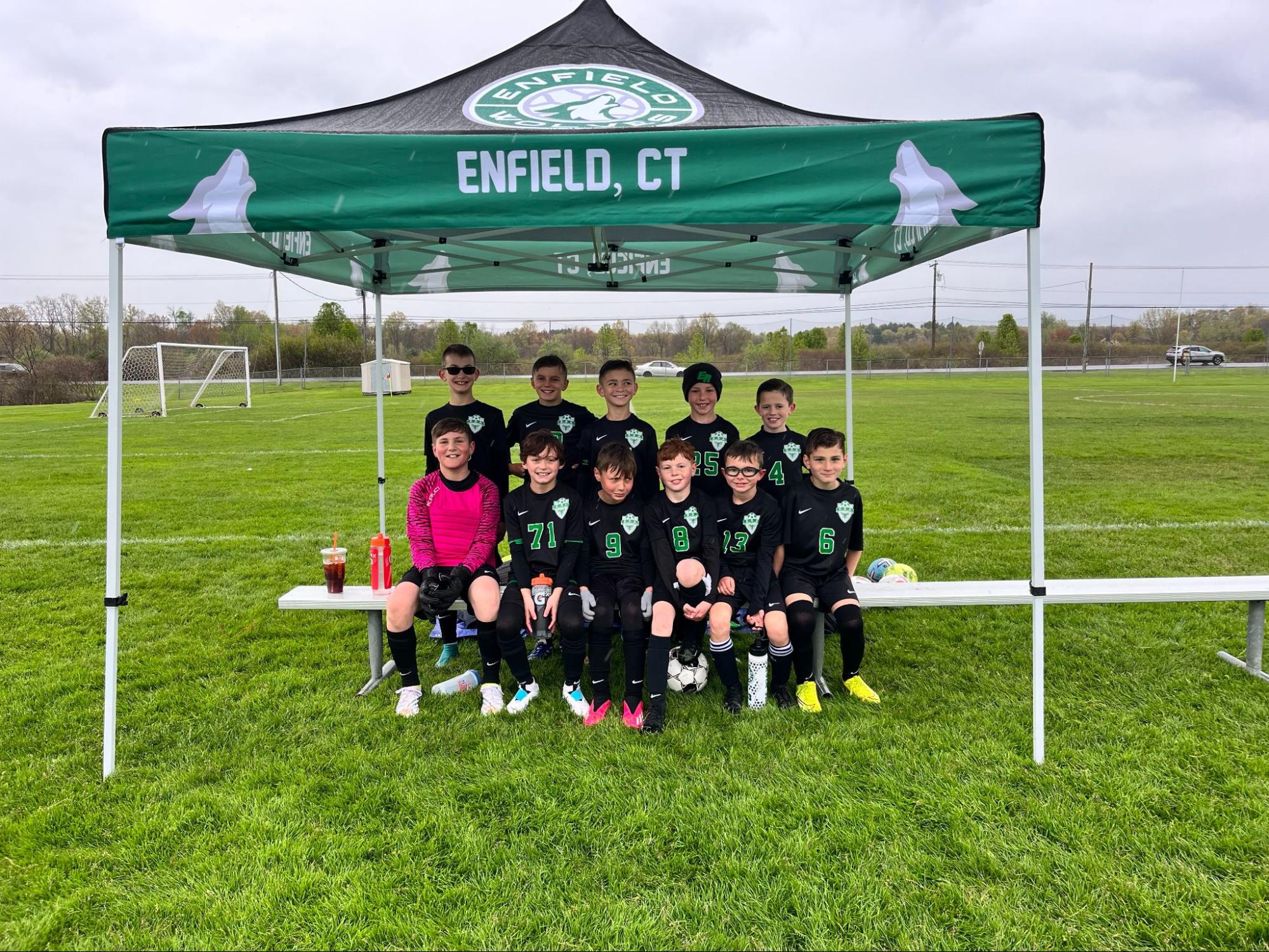 Youth soccer team under a green Enfield, CT school canopy