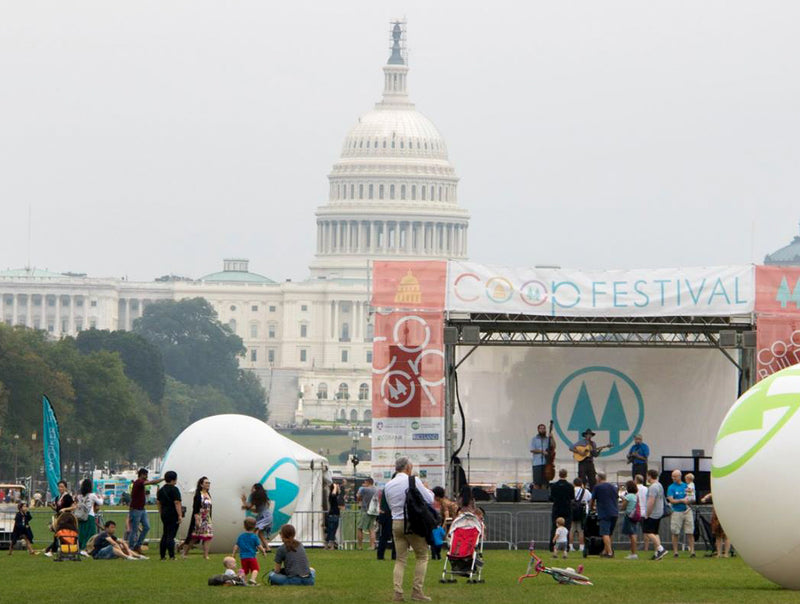 custom giant mesh banners featuring coop festival logo set during outdoor event
