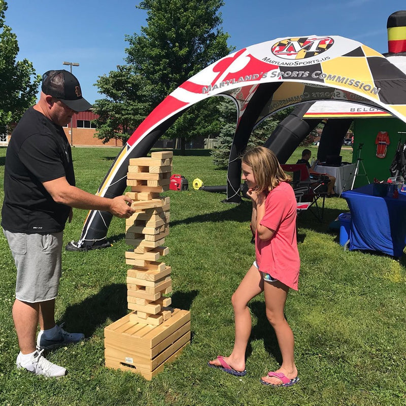 custom inflatable dome tent branded for maryland sports commission with attendees playing interactive games