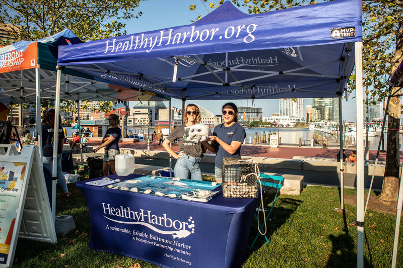 stretch table cover personalized for HealthyHarbor brand under a custom 10x10 canopy tent