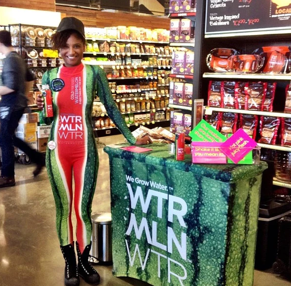 Trade show table covers with logo, featuring WTRMLN WTR’s vibrant watermelon design and product samples