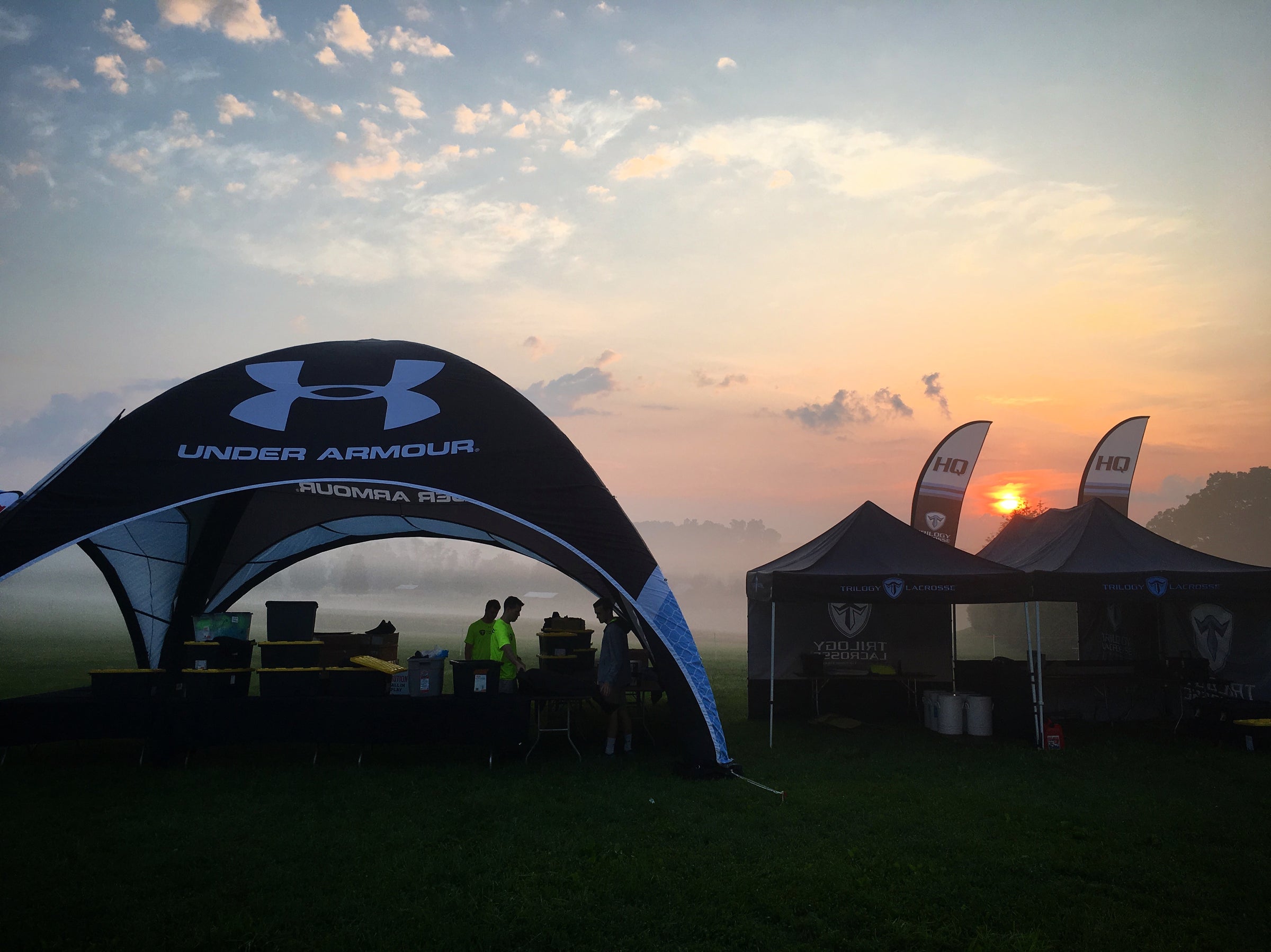 a large inflatable dome tent sponsored by under armor for a lacrosse team on a green field