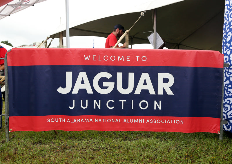 personalized rectangular outdoor vinyl banner hung around the fence using grommets