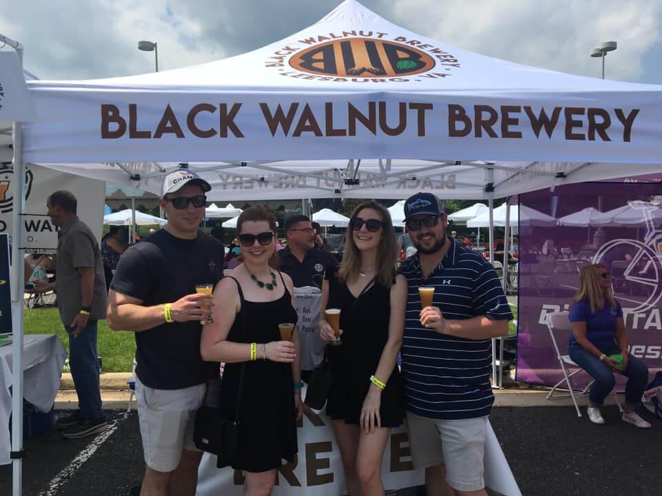 Black Walnut Brewery custom canopy tent at outdoor beer festival with attendees enjoying craft beer