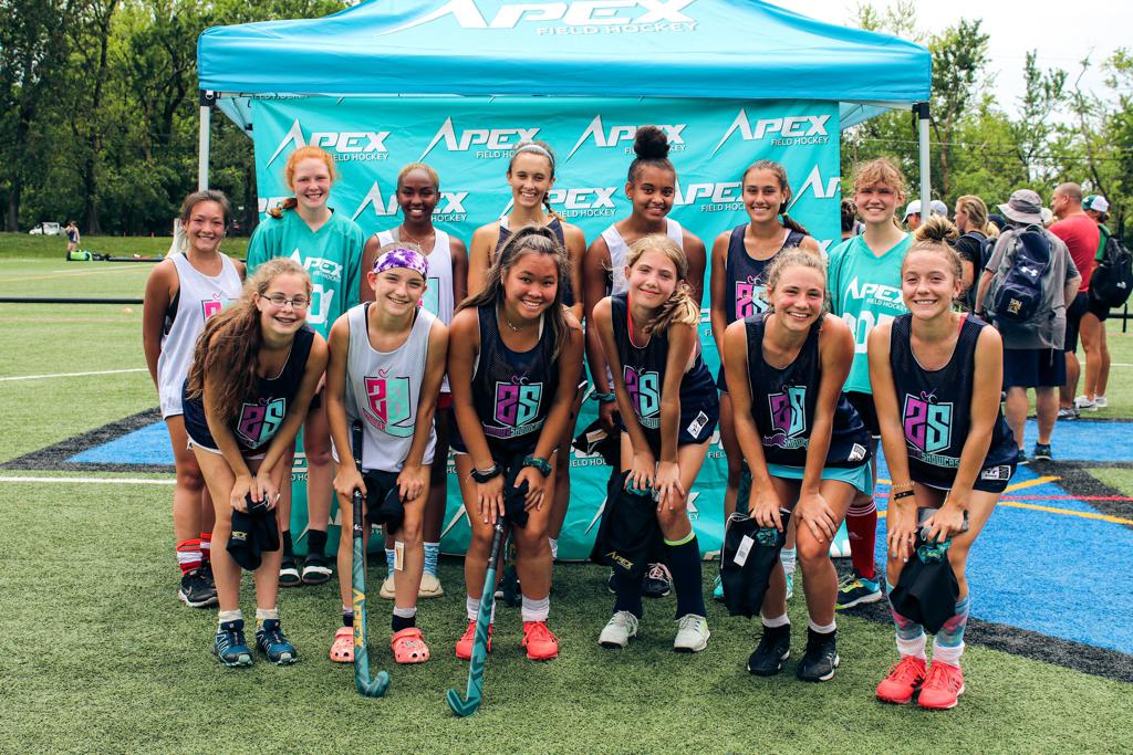 a women's field hockey team photo shoot Infront of branded sports canopy tent