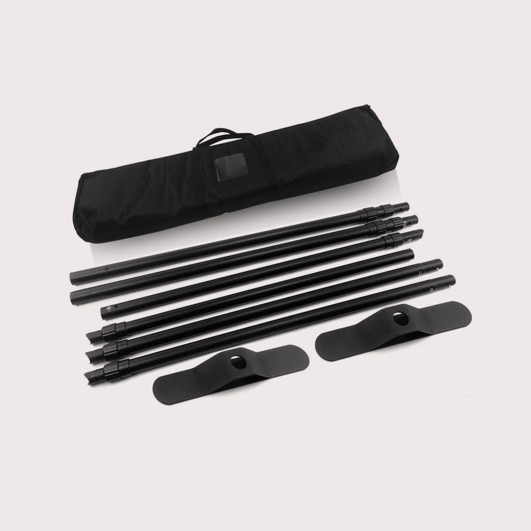 Disassembled black trade show banner stand with poles, bases, and a carrying bag for portable display backdrop setup