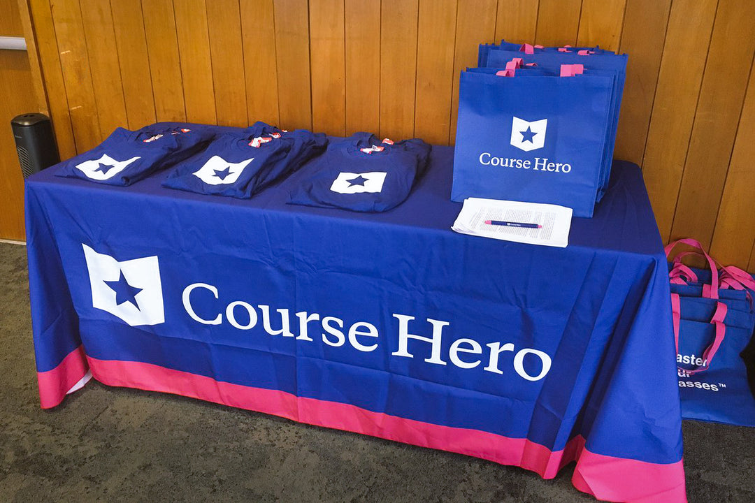 Course Hero promotional table at a trade show with a branded table throw and giveaways