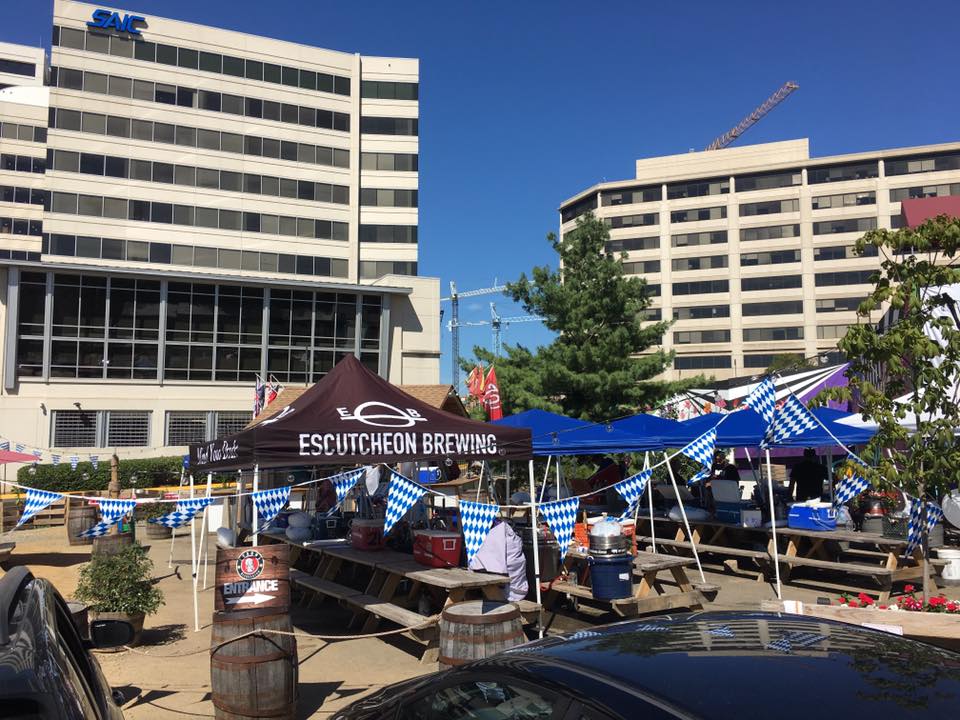 Festive brewery outdoor seating tents with colorful banners and a vibrant street-side setup