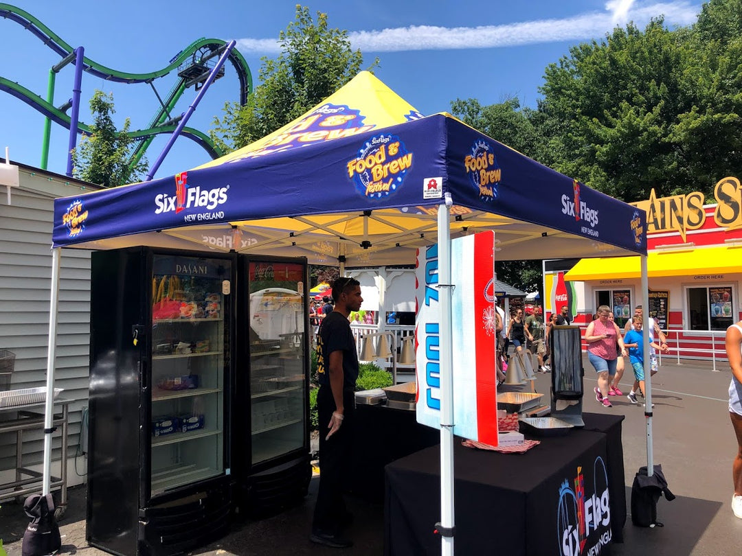 Six Flags 'Food & Brew' festival food tent with rollercoaster in background