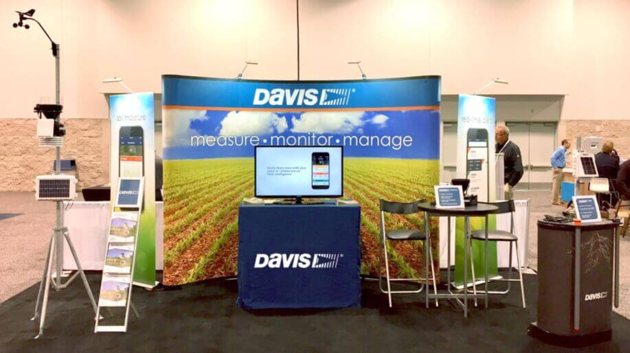 Davis Instruments trade show booth with a branded backdrop and display tables