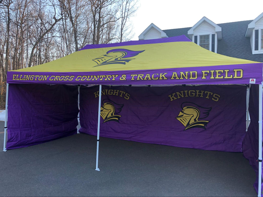 A 10 x 20 Ellington Cross Country & Track and Field tent, purple and yellow, stands proudly outside