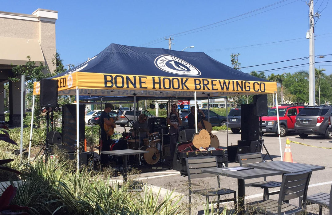 Live band playing under an outdoor 10x20 canopy tent at Bone Hook Brewing Co for a lively atmosphere