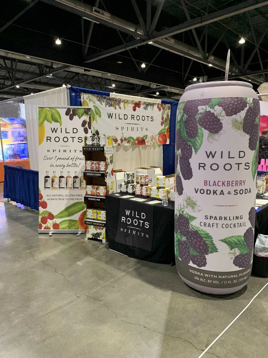 nflatable product replica of Wild Roots Blackberry Vodka & Soda at a 10 x 10 trade show booth