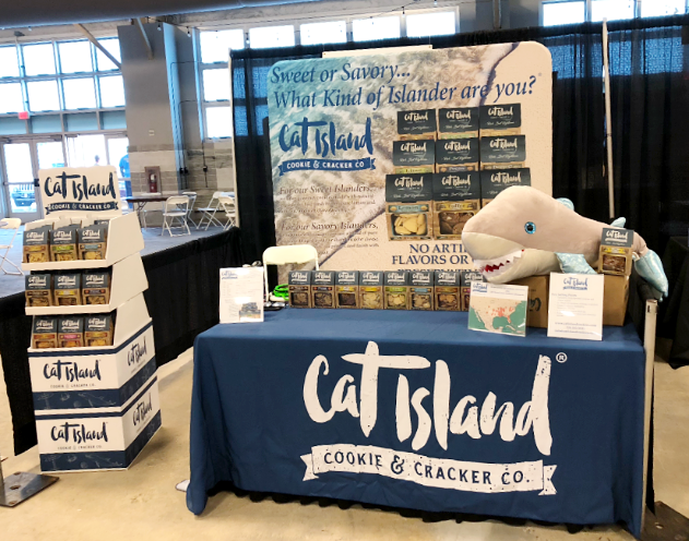 Custom logo table runner at a trade show booth for Cat Island Cookie & Cracker Co
