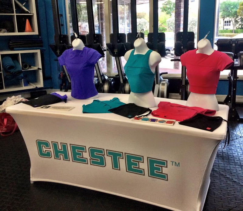 Custom spandex table cover with Chestee logo at a product display booth