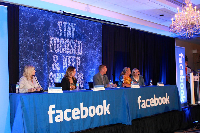 Branded table runner with Facebook logo at a professional panel discussion event