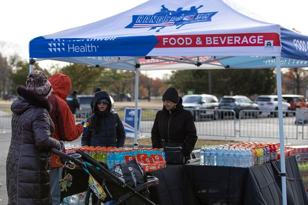 Attendees at the NY Rangers 5K gather at the Food & Beverage tent on a chilly morning