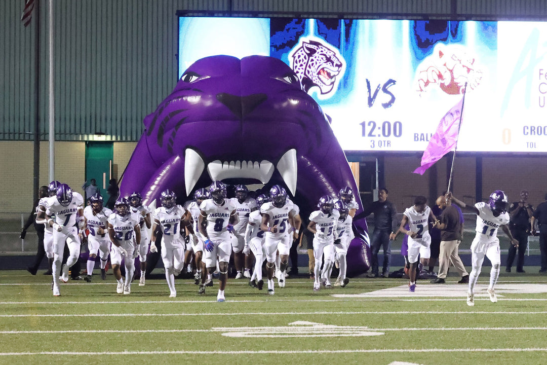LBJ Jaguars high school football mascot tunnel with players running out of the tunnel