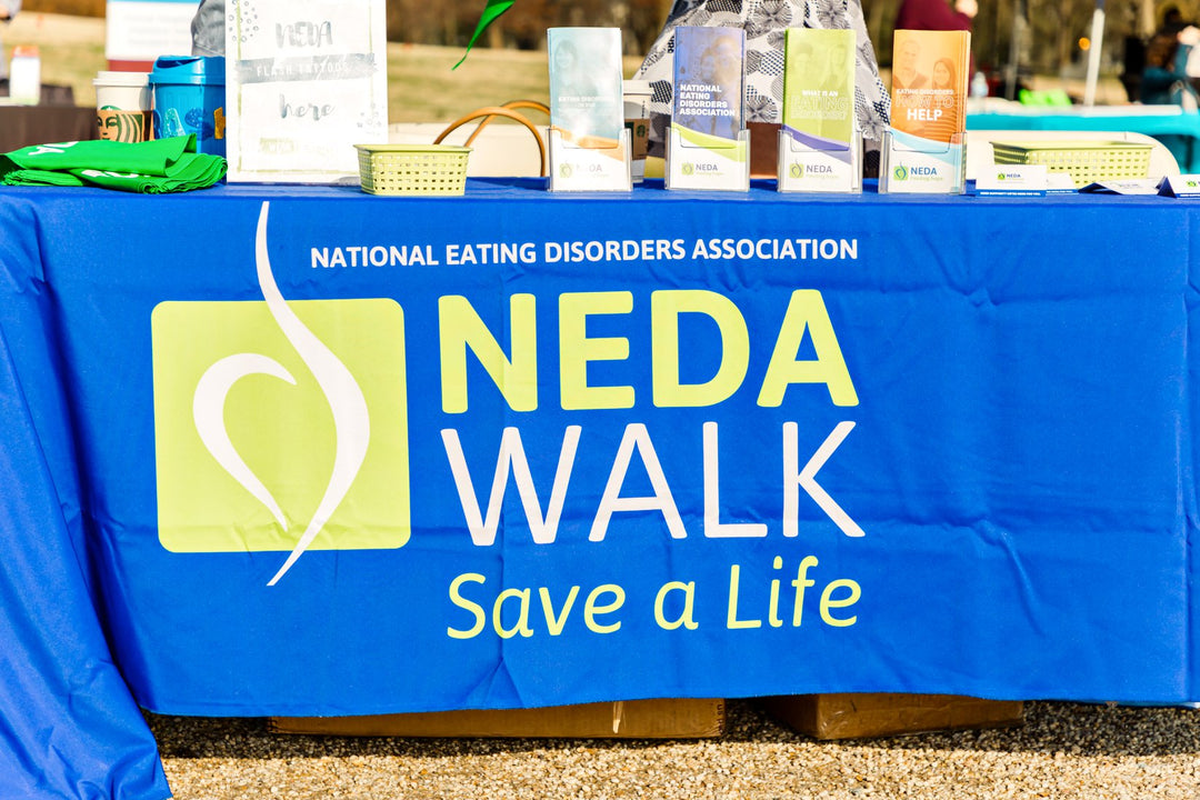 Blue table cover customized with NEDA WALK Save a Life nonprofit event branding.