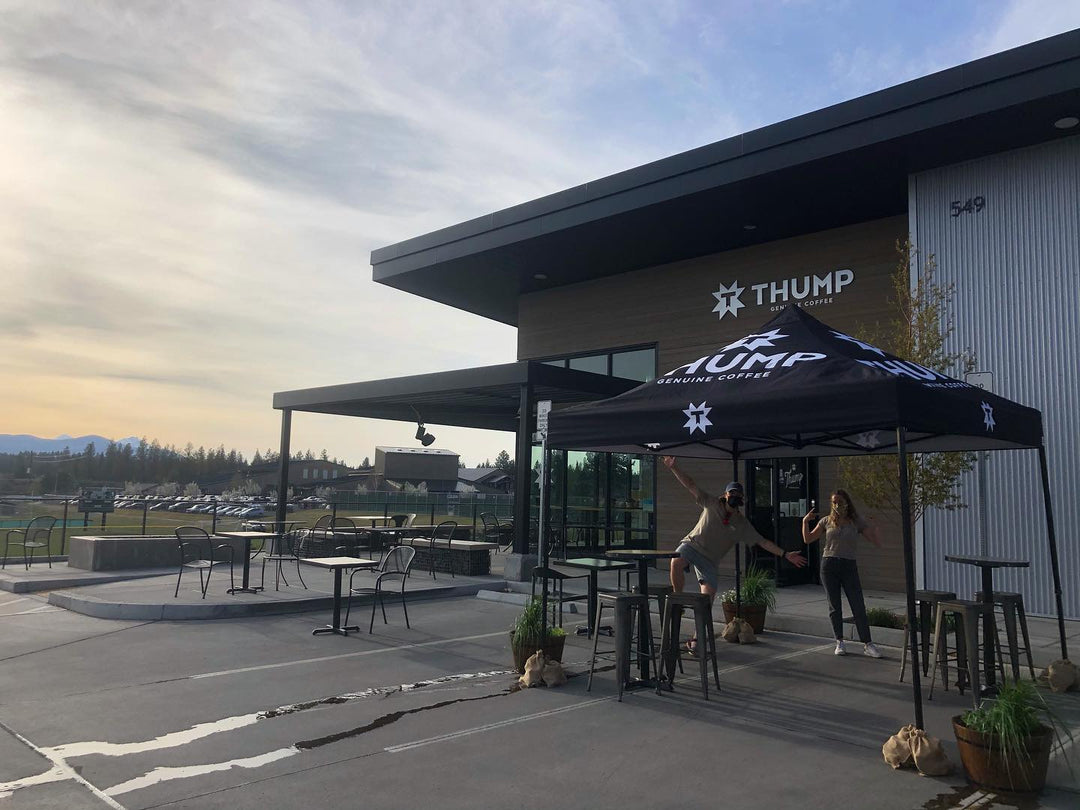 Outdoor dining tents at Thump Coffee with mountain views for a relaxed patron experience