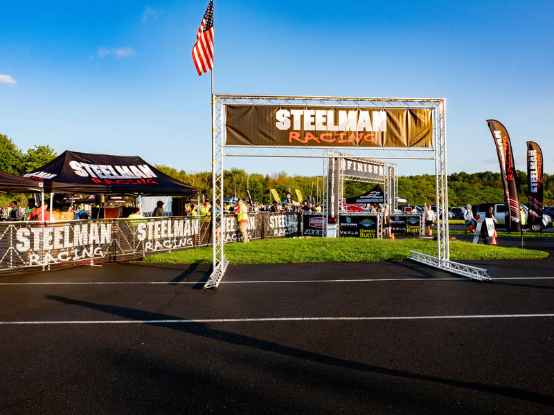 Steelman Racing custom outdoor event vinyl banner with grommets at finish line