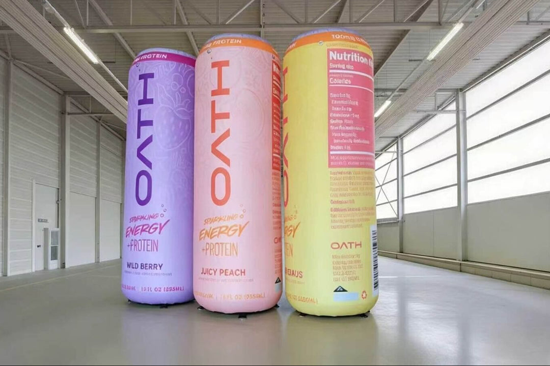 Three energy drink cans labeled 'OATH' in a warehouse setting.
