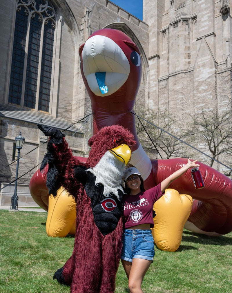 university of chicago inflatable mascot and a fan posing in front for a photo op