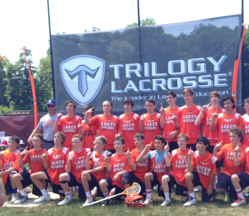 mesh banner of trilogy lacrosse team with full team members posing for a photo op