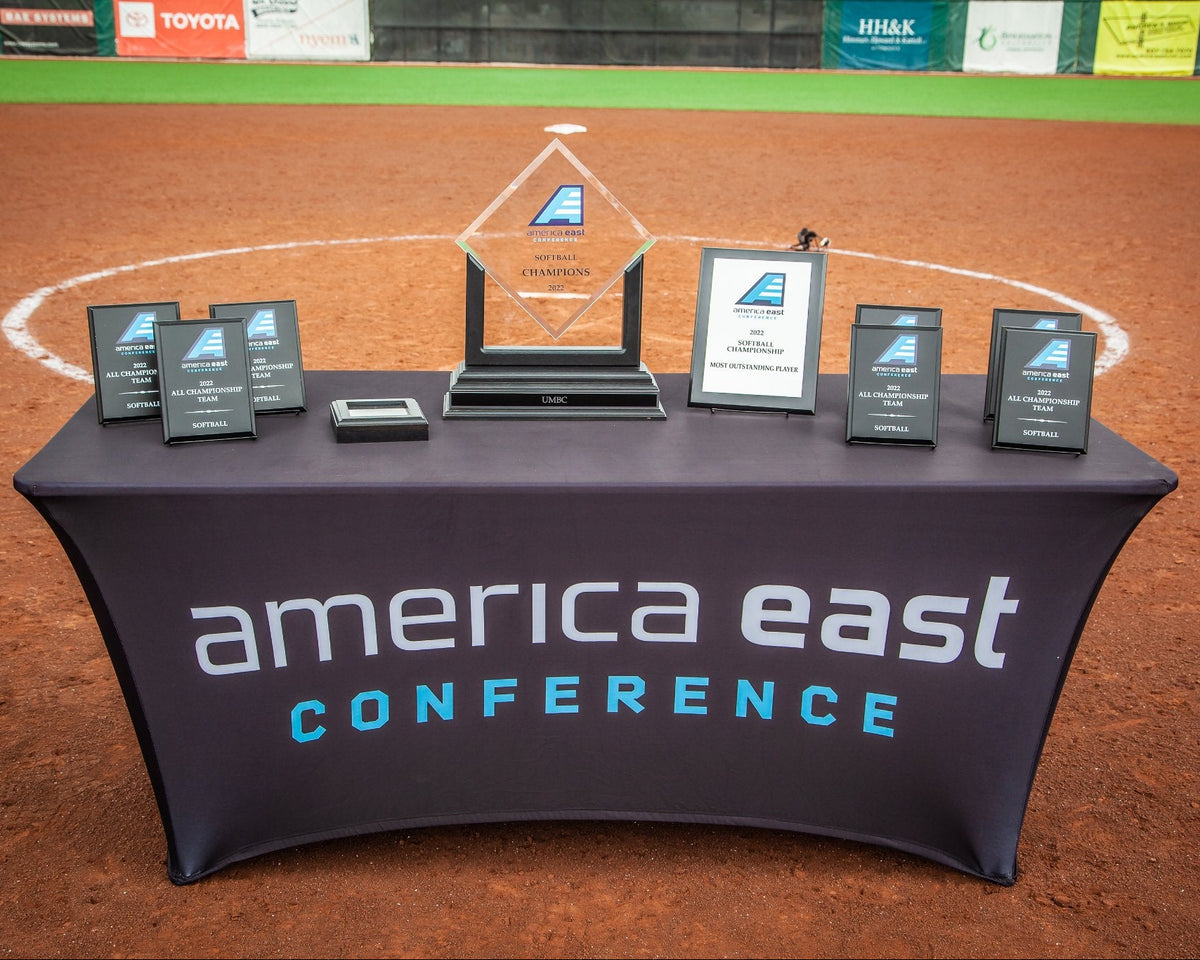 Table with America East Conference branding on a sports field background