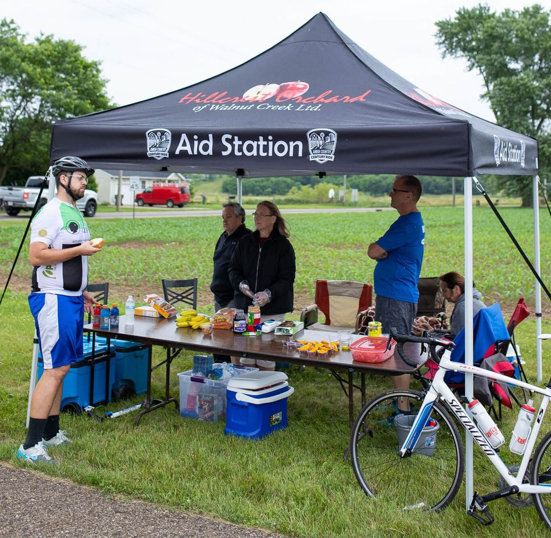 Hillcrest Orchard of Walnut Creek Ltd. custom canopy tent at Amish Country Century Ride aid station with cyclists and refreshments