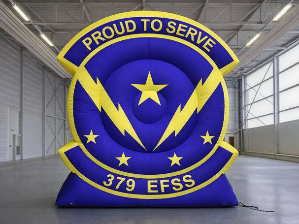 Large inflatable sign with 'Proud to Serve' and '379 EFSS' text in a warehouse setting.
