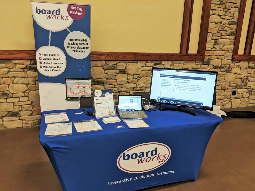 Boardworks trade show booth featuring a blue stretch spandex tablecloth with interactive displays