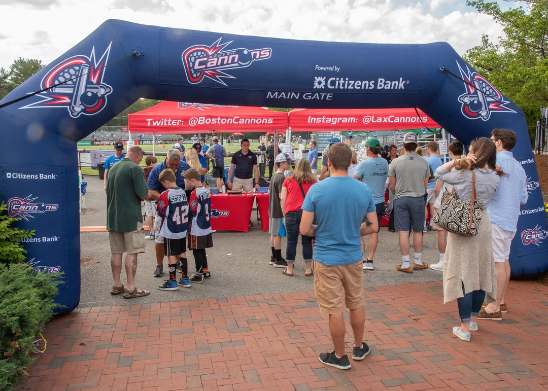 Crowd entering sports event through custom Boston Cannons inflatable arch sponsored by Citizens Bank