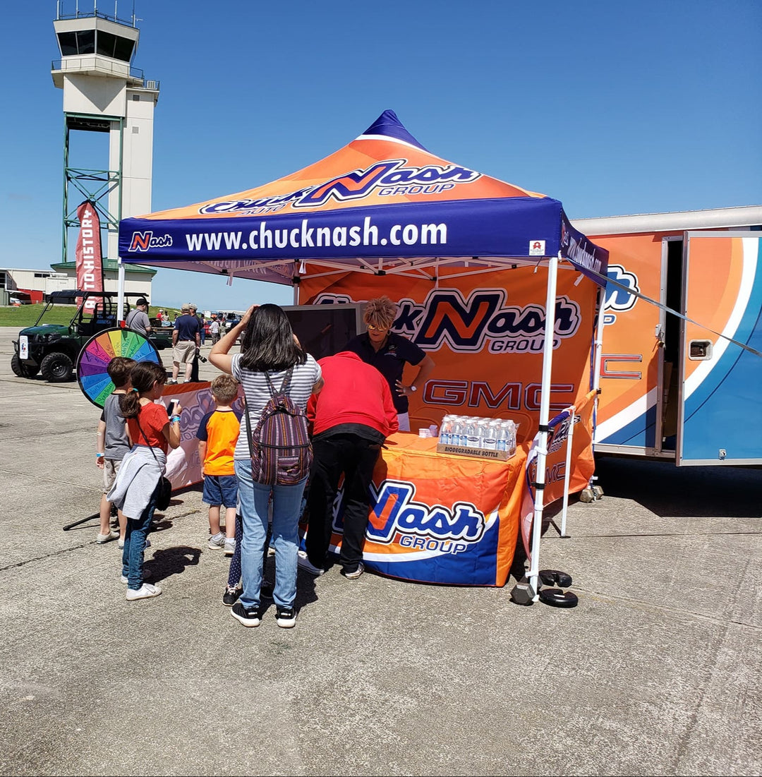 Chuck Nash Auto Group custom canopy tent at outdoor brand activation event with giveaway booth and visitor engagement
