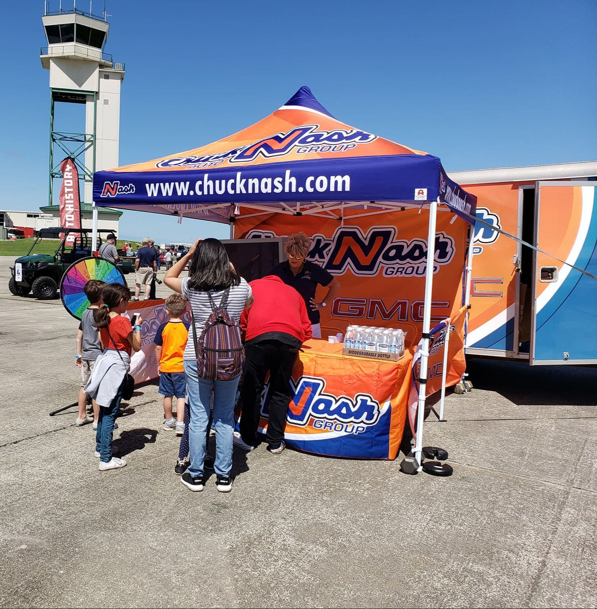 Chuck Nash Auto Group custom canopy tent at outdoor brand activation event with giveaway booth and visitor engagement