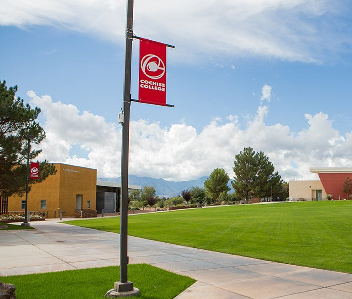 Cochise College red light pole banner along the walk way within the school premises.