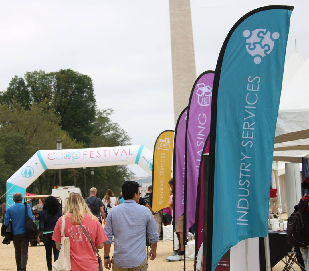 Series of feather flags for different service categories at a Coop Festival near the Washington Monument.