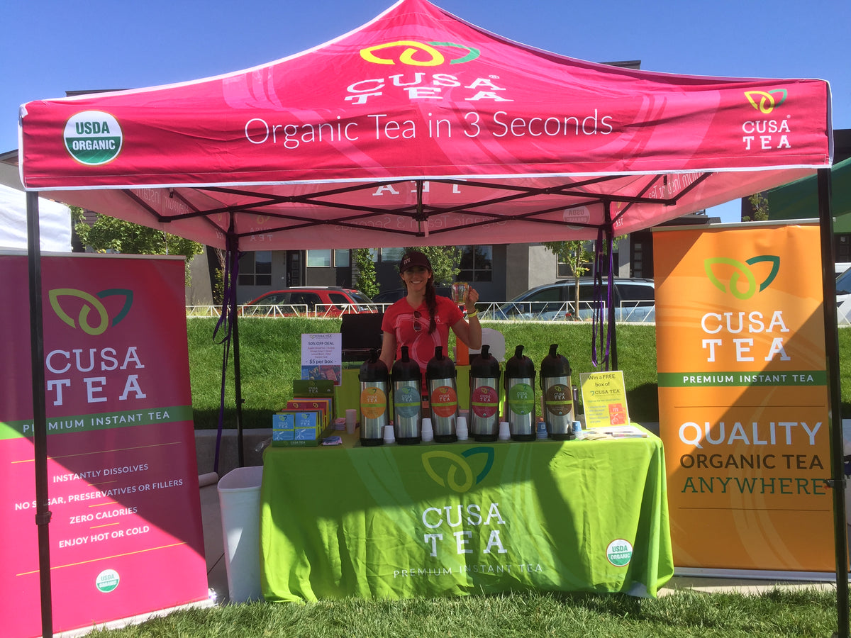 Cusa Tea 10x10 canopy tent with premium instant tea branding at outdoor sampling booth