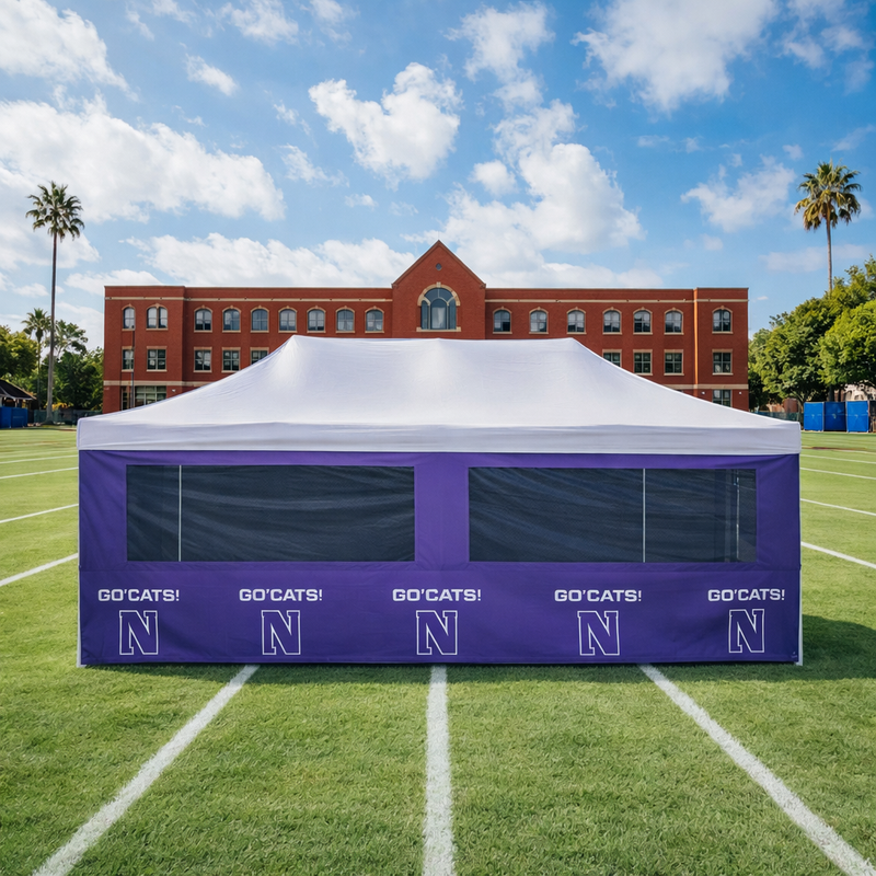 Purple and white tent with 'GO'CATS!' and 'N' branding on a sports field.