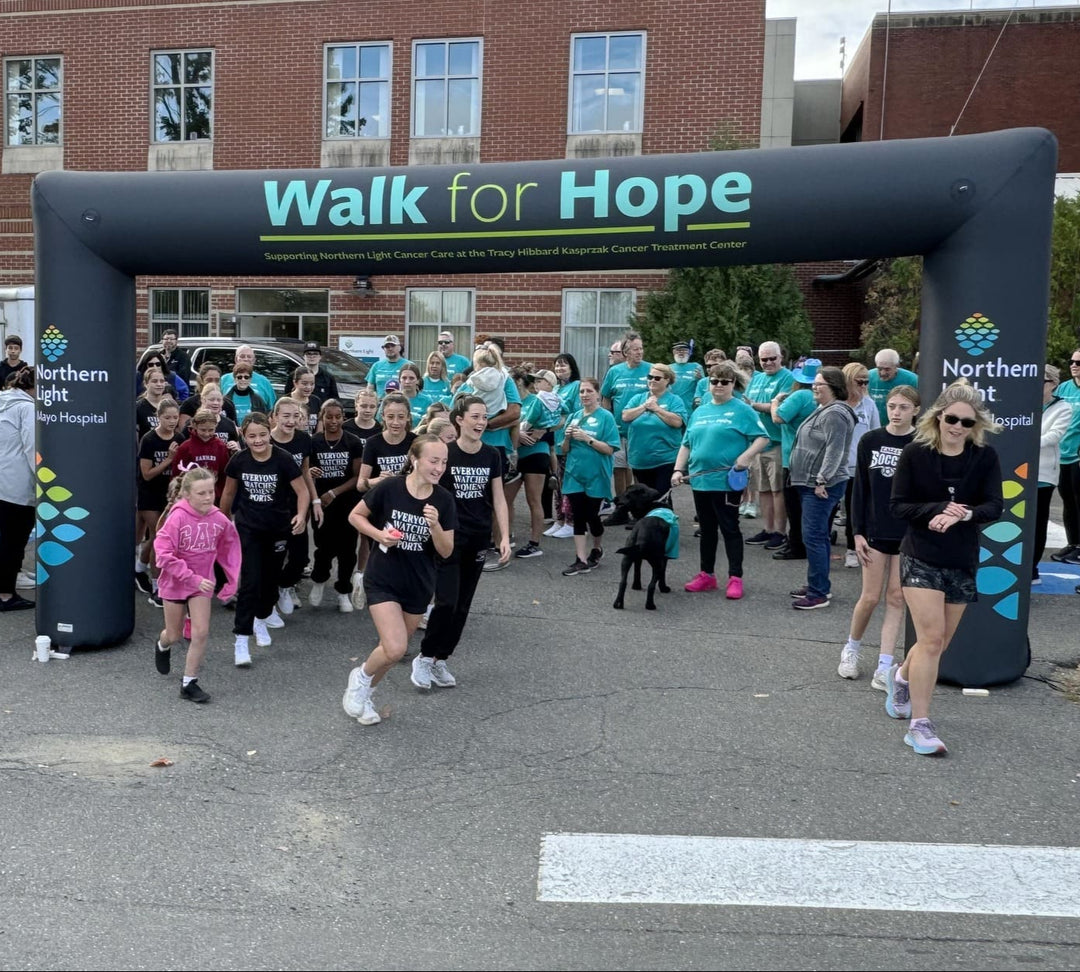 Custom black inflatable arch for Northern Light Mayo Hospital Walk for Hope event with participants at starting line