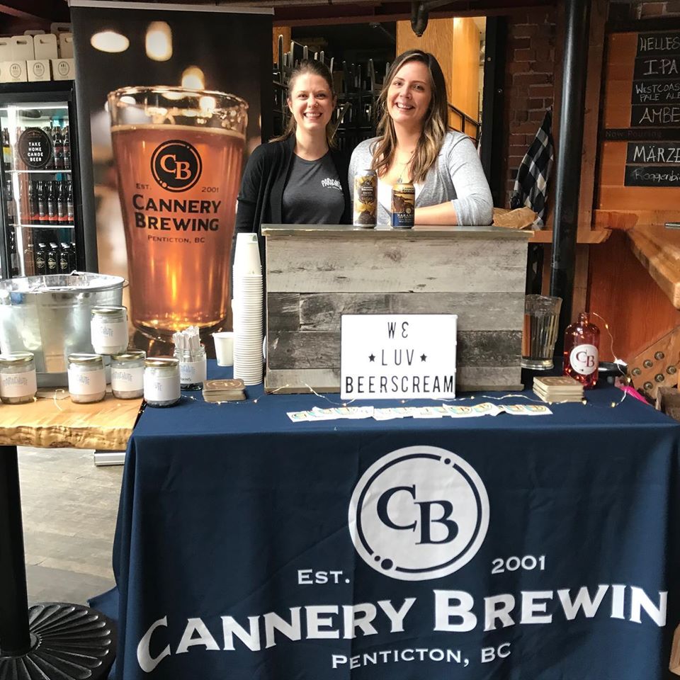 Custom table cover for Cannery Brewing Co. indoor event booth with beer samples and branded display