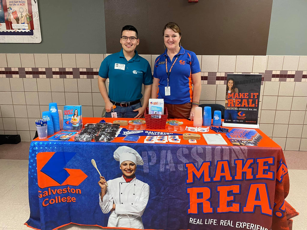 Custom printed table cover for Galveston College recruitment event with educational materials and giveaways