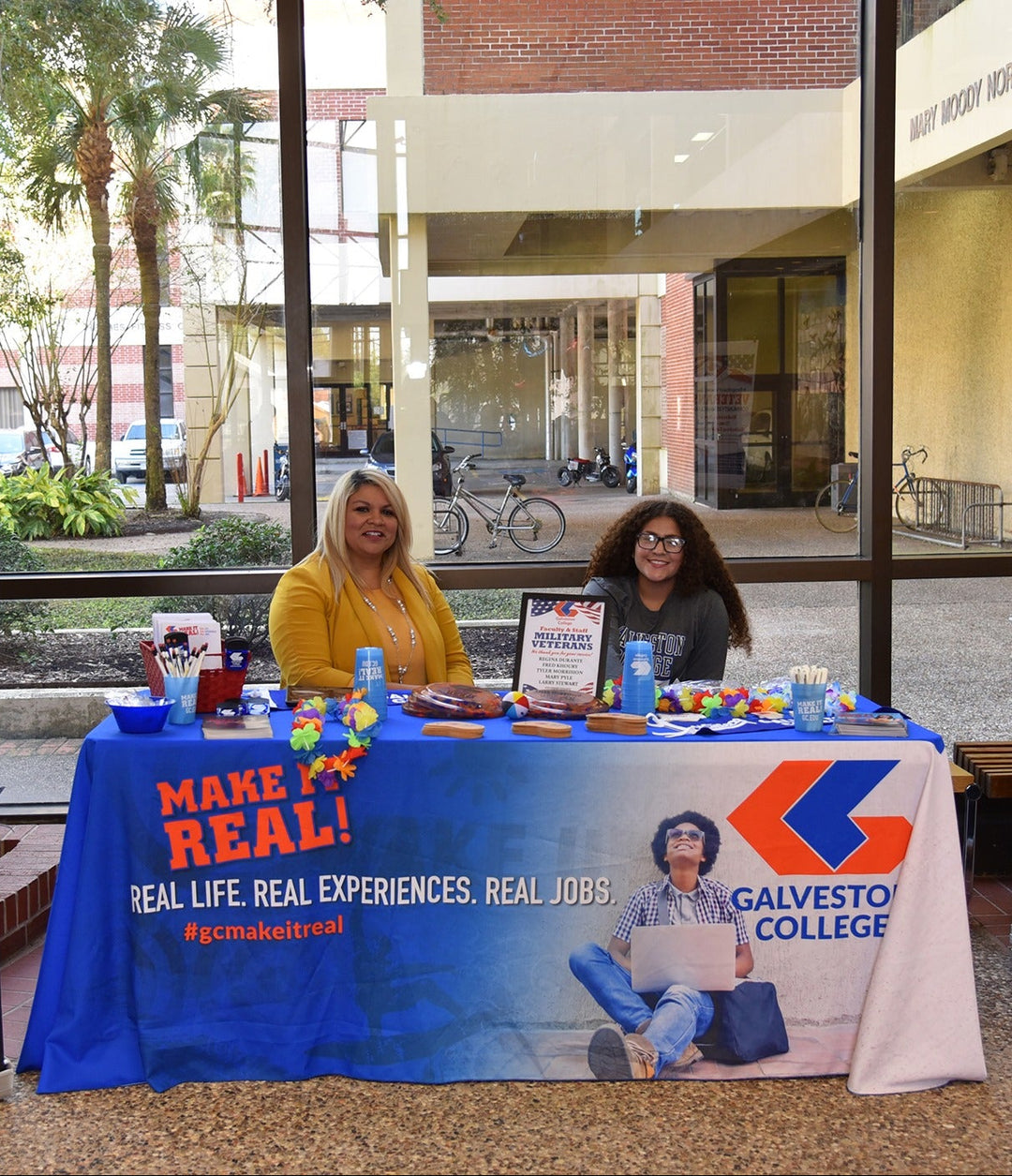 Custom printed table cover for Galveston College military and veterans outreach booth with promotional materials