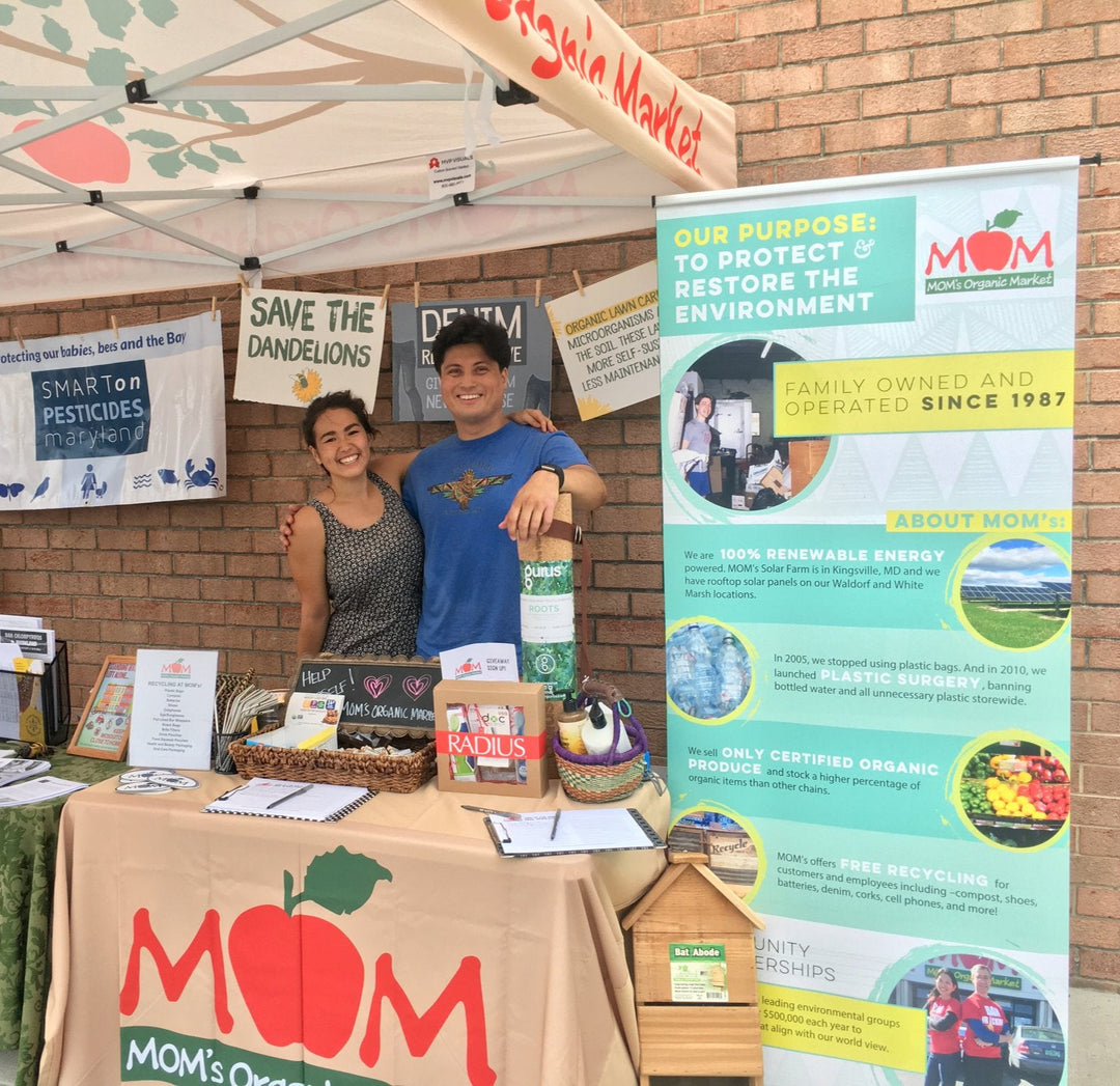 Custom table cover for MOM's Organic Market outdoor sustainability booth promoting renewable energy and eco initiatives