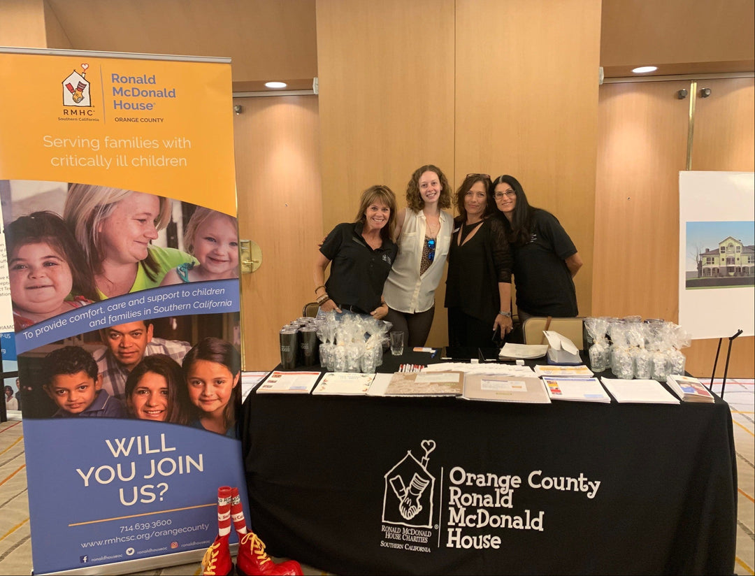 Custom table cover for Orange County Ronald McDonald House at nonprofit outreach event with informational display