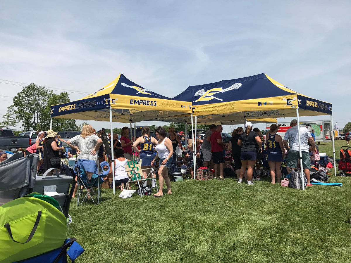 Two custom 10x20 and 10x10 canopy tents for Empress Lacrosse providing team shade during outdoor tournament