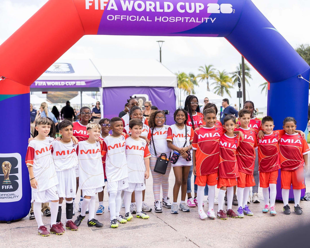 Children’s soccer team posing under FIFA World Cup Official Hospitality inflatable arch