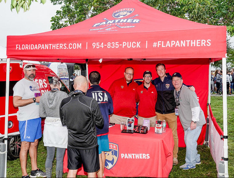 Florida Panthers branded canopy tent at fan engagement event with team reps and community participants
