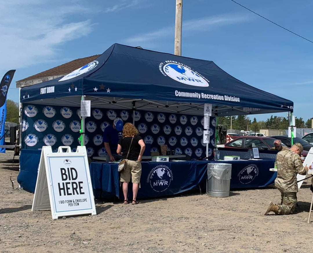 Fort Drum MWR 10x20 canopy tent set up for community recreation auction event with bidding station